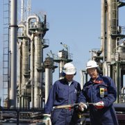 engineers inside large oil refinery